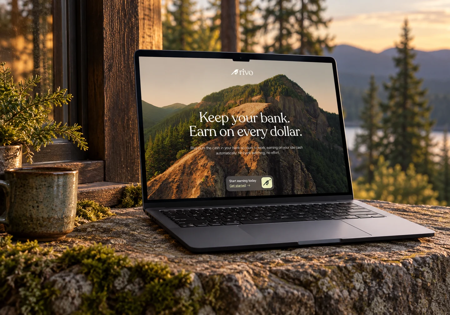 Rivo homepage on a MacBook on a stone ledge beside a forest cabin window.